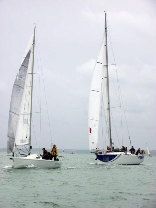 Little and large - Boysterous is chased towards the finish line by the Sunsail F40 © Phil Riley